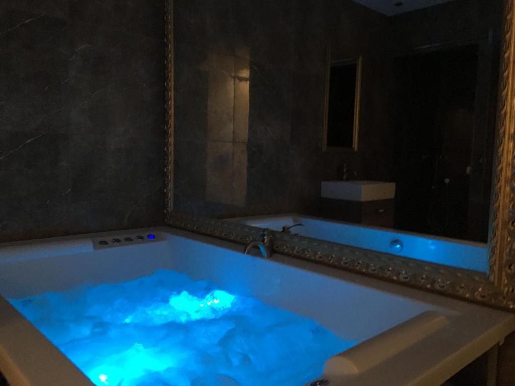 a bath tub with blue lights in a bathroom at Central Business Apartments Jacuzzi in Belgrade