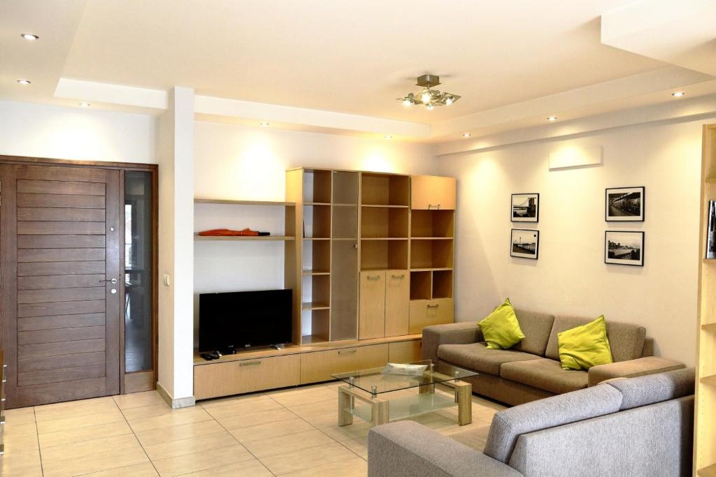 a living room with a couch and a television at Kornesios Suite in Nicosia