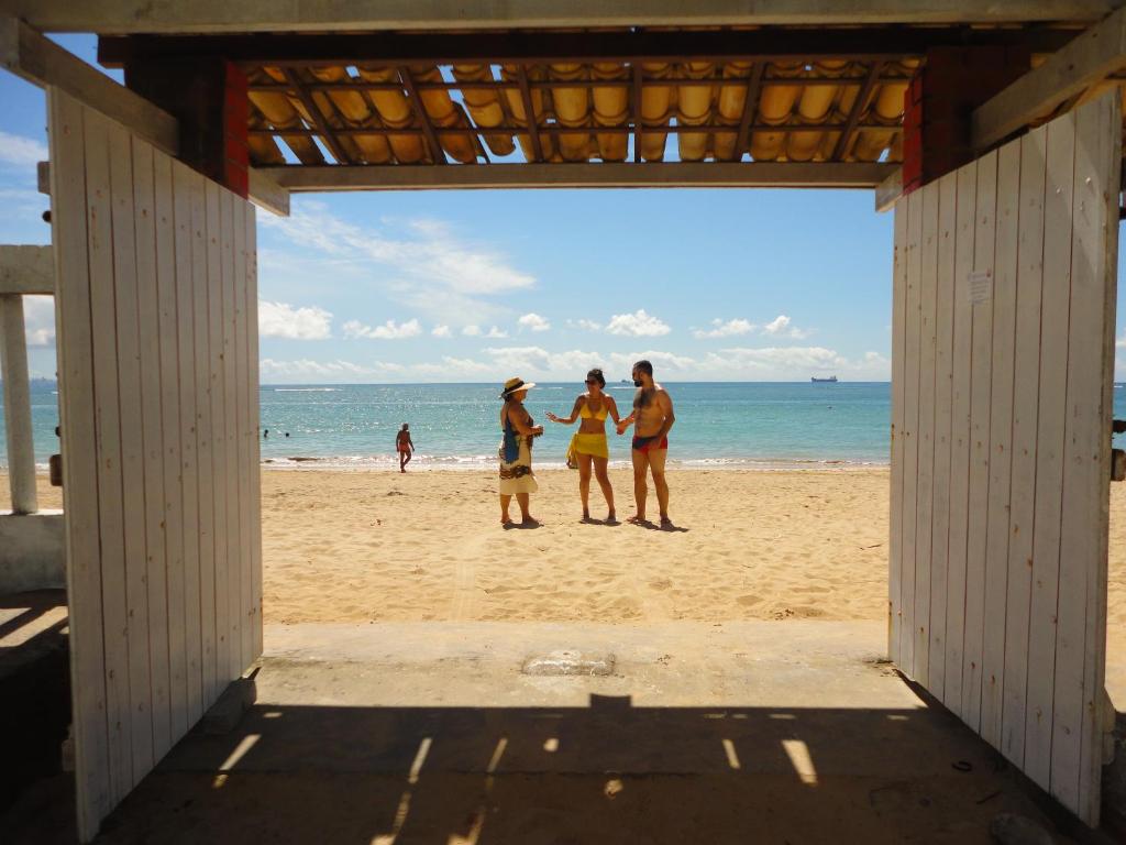three people standing on the beach at Reduto do Sossego in Vera Cruz de Itaparica