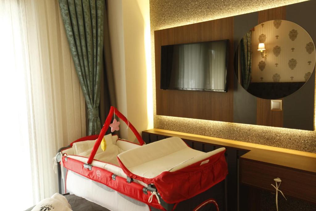 A bed or beds in a room at Grande Stella Hotel