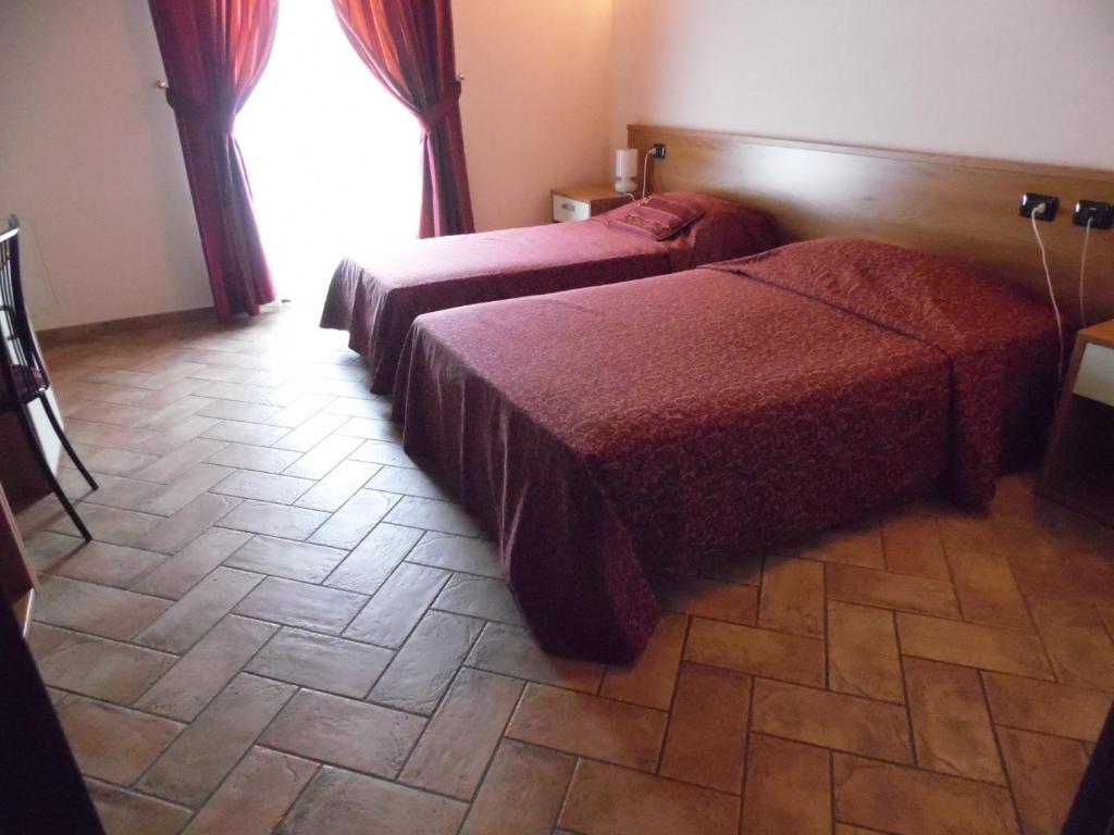 Postel nebo postele na pokoji v ubytování Hotel Agli Ulivi