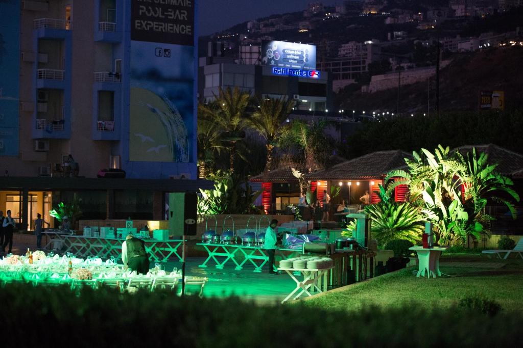 a resort with a pool at night at Four Seasons Halat in Jbeil