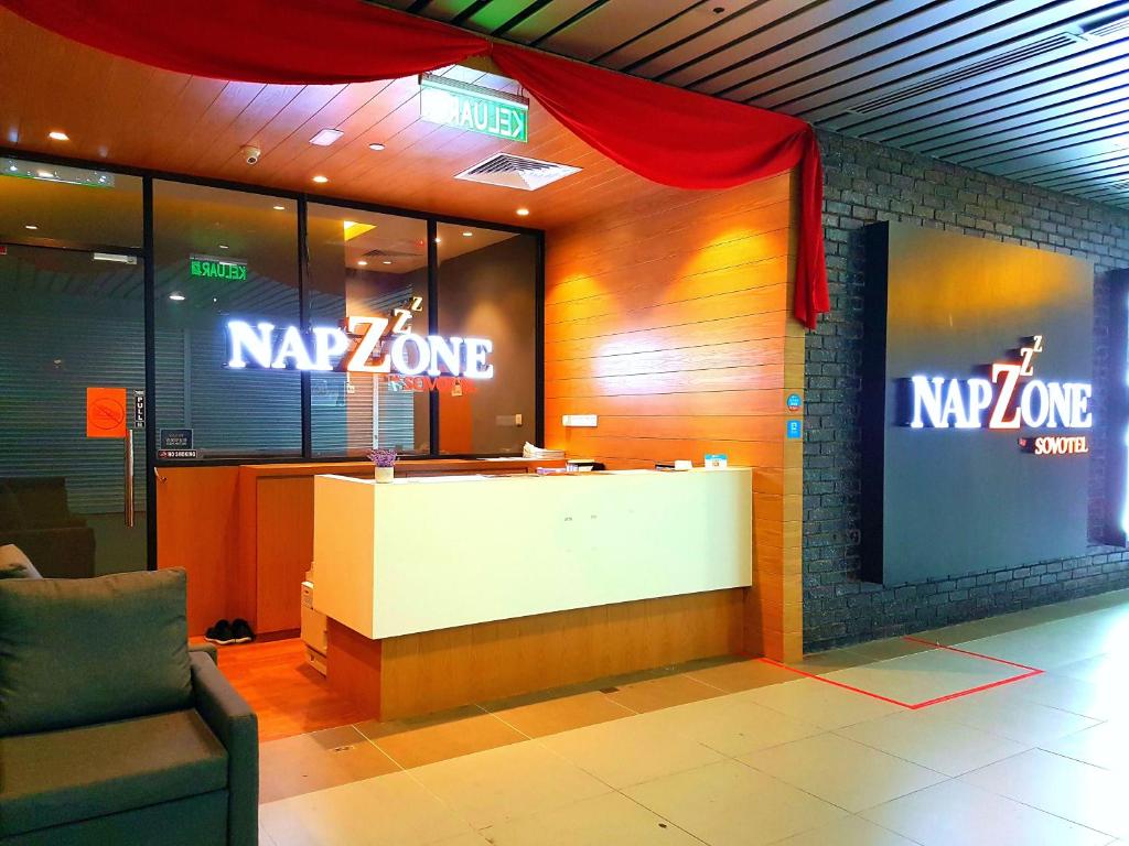 a lobby with a nz zone sign on the wall at Sovotel @ Napzone KKIA in Kota Kinabalu