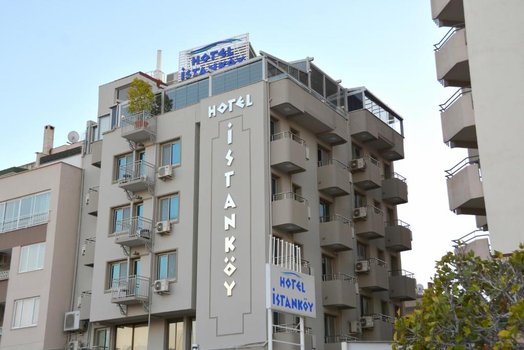 a building with a hotel sign on the side of it at Istankoy Hotel in Kuşadası
