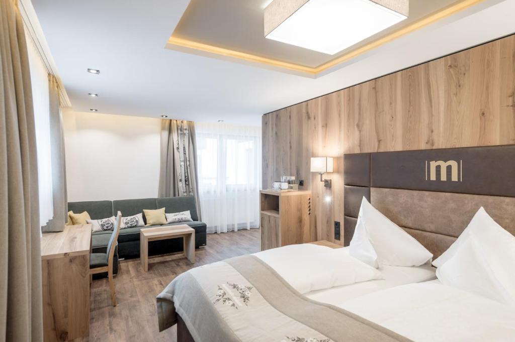 Postel nebo postele na pokoji v ubytování Hotel Mondin