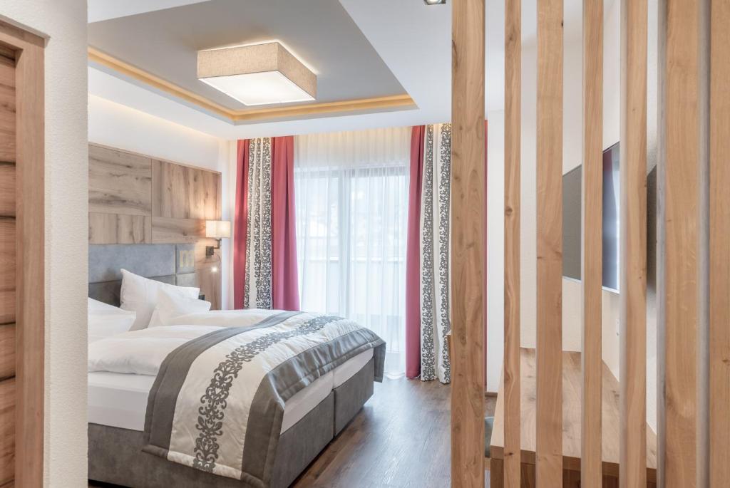 Postel nebo postele na pokoji v ubytování Hotel Mondin