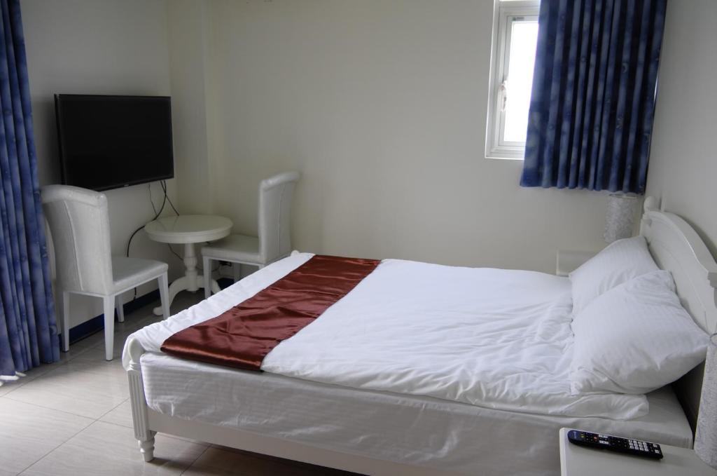 Postel nebo postele na pokoji v ubytování New Zhilan B&B