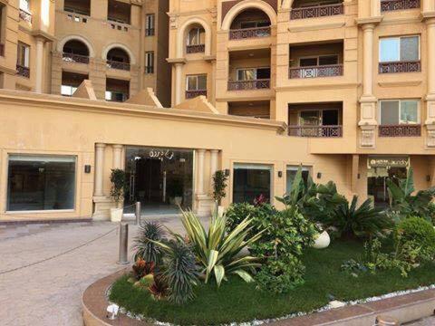 een groot gebouw met een bos planten ervoor bij Mohamed Afifi Florence El Montazah - 2 Bed rooms - "Compound" in Alexandrië