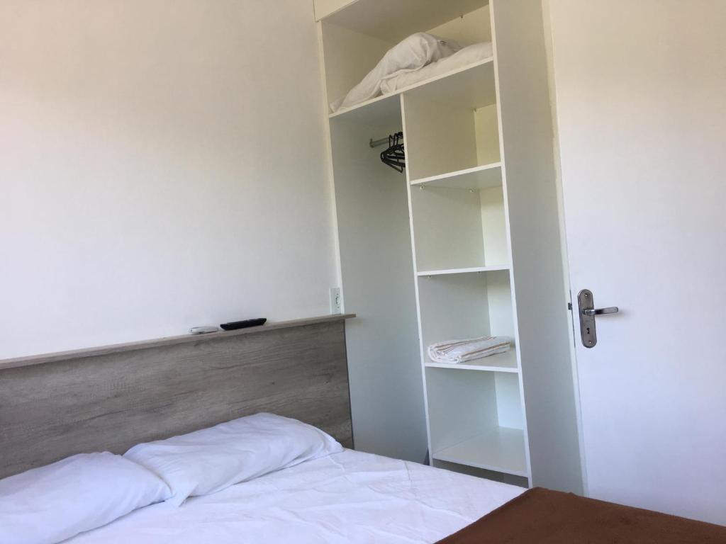 Postel nebo postele na pokoji v ubytování Residencial Neto