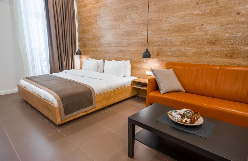 a hotel room with a bed and a couch at Luxury Apartments on Central Avenue in Tbilisi City