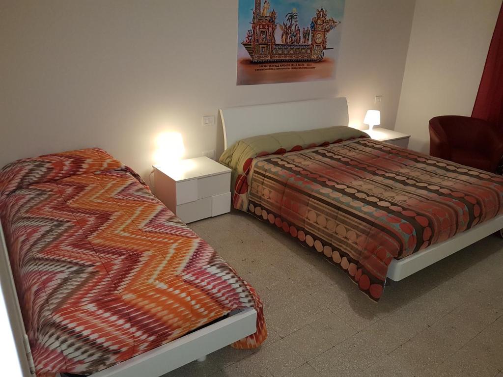 Postel nebo postele na pokoji v ubytování B&B Nonna Rosaria