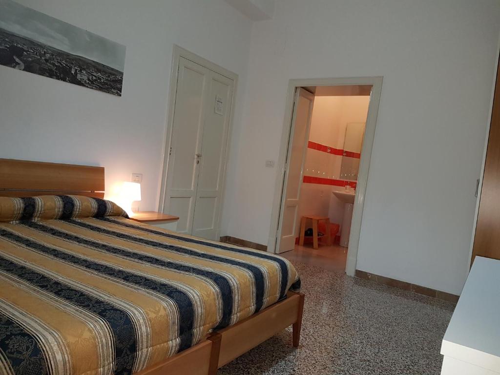 Postel nebo postele na pokoji v ubytování B&B Nonna Rosaria