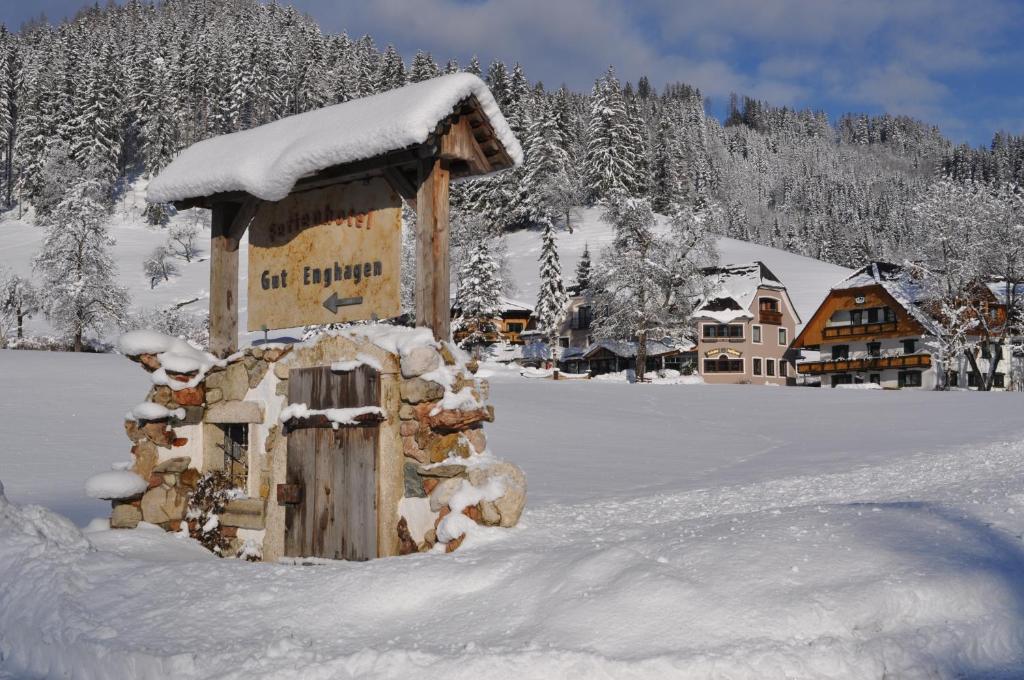 a small building in the snow in a snow covered village at Ferienhotel Gut Enghagen in Rossleithen