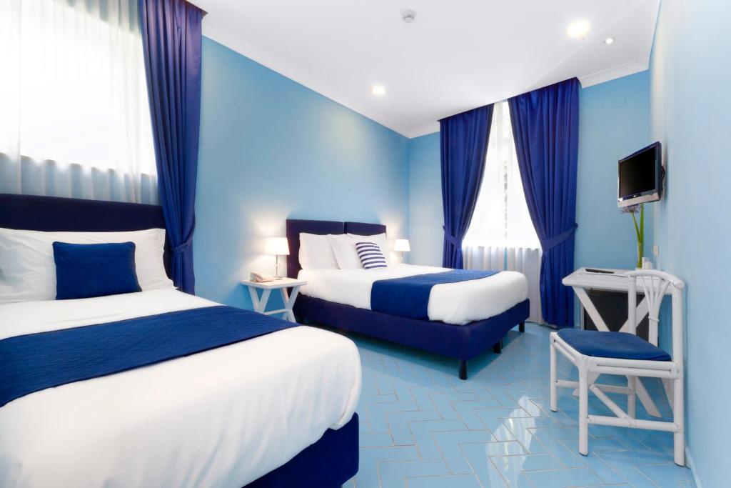 Postel nebo postele na pokoji v ubytování Hotel Bougainville