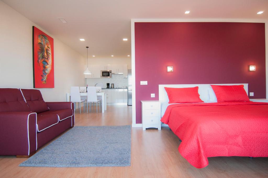 a red bedroom with a bed and a couch at Los Rodeos Luxury Vivienda Vacacional in La Laguna