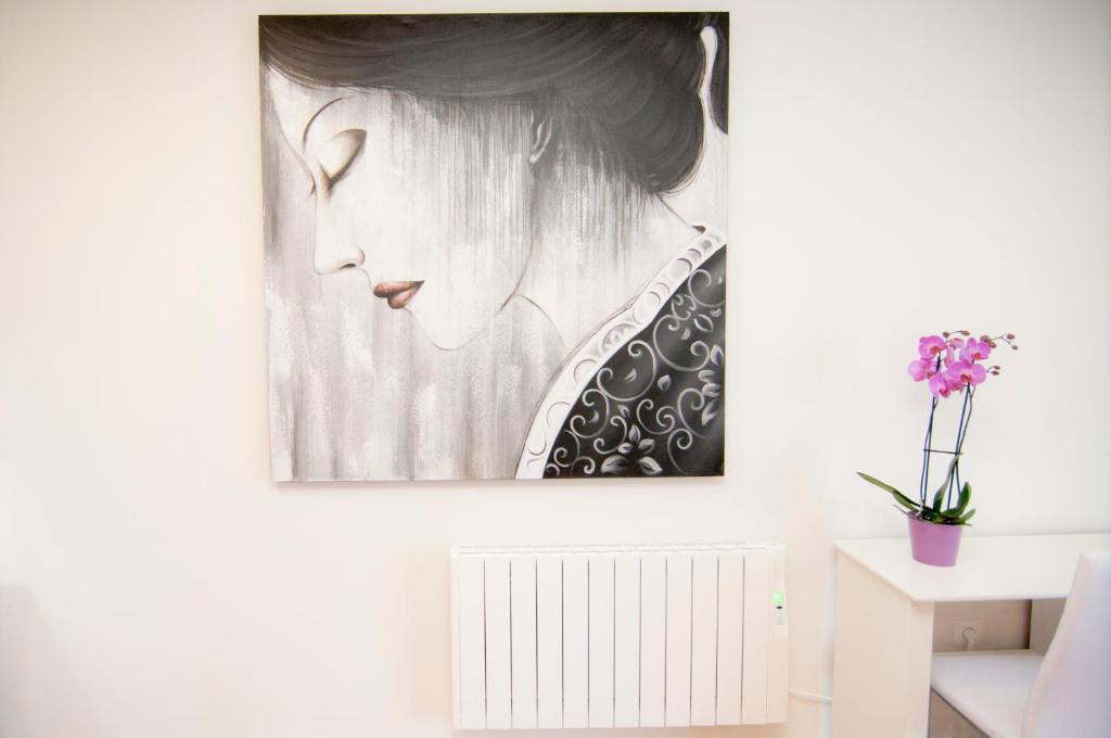 a painting of a woman hanging on a wall at Los Rodeos Luxury Vivienda Vacacional in La Laguna