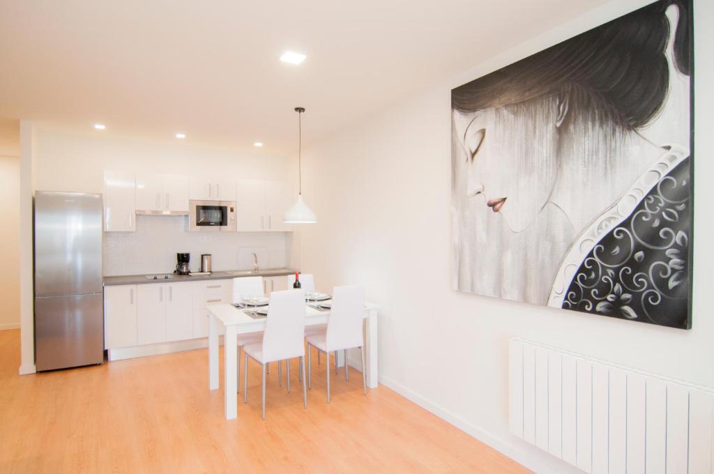 a kitchen with a table and a painting on the wall at Los Rodeos Luxury Vivienda Vacacional in La Laguna