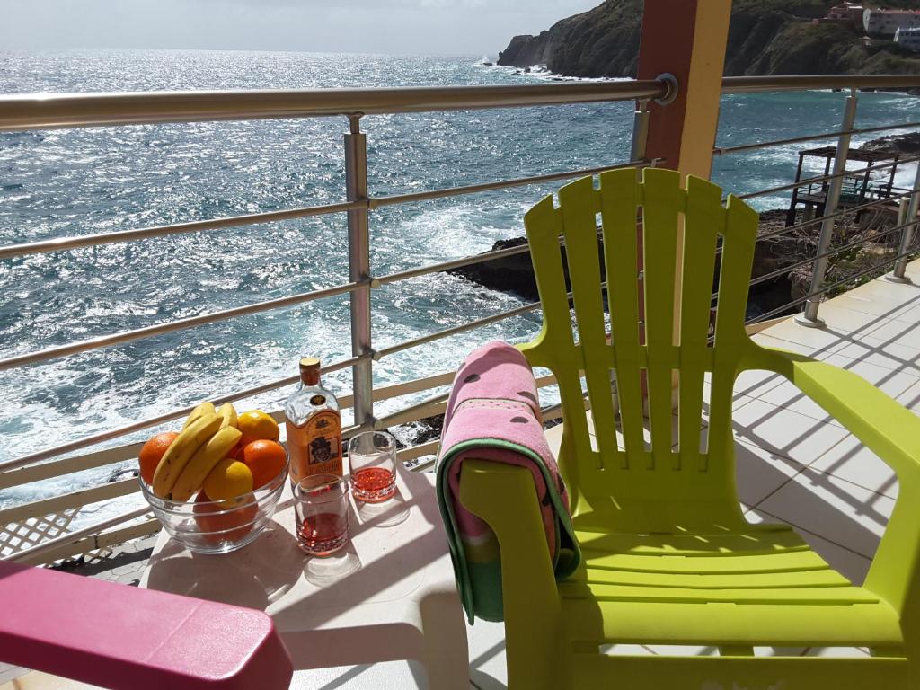 two chairs and a table with fruit on a cruise ship at Ocean Shore in Philipsburg