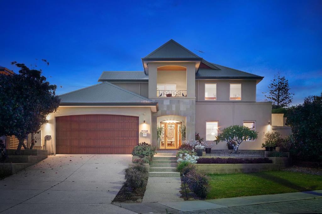 a large house with a garage in front of it at Sorrento Beach Bed & Breakfast in Perth