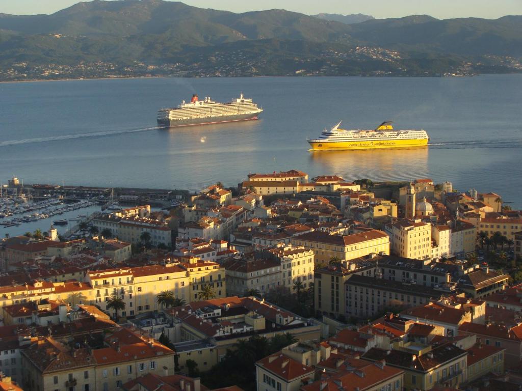 two cruise ships in the water near a city at LE PIGEONNIER Ajaccio in Ajaccio