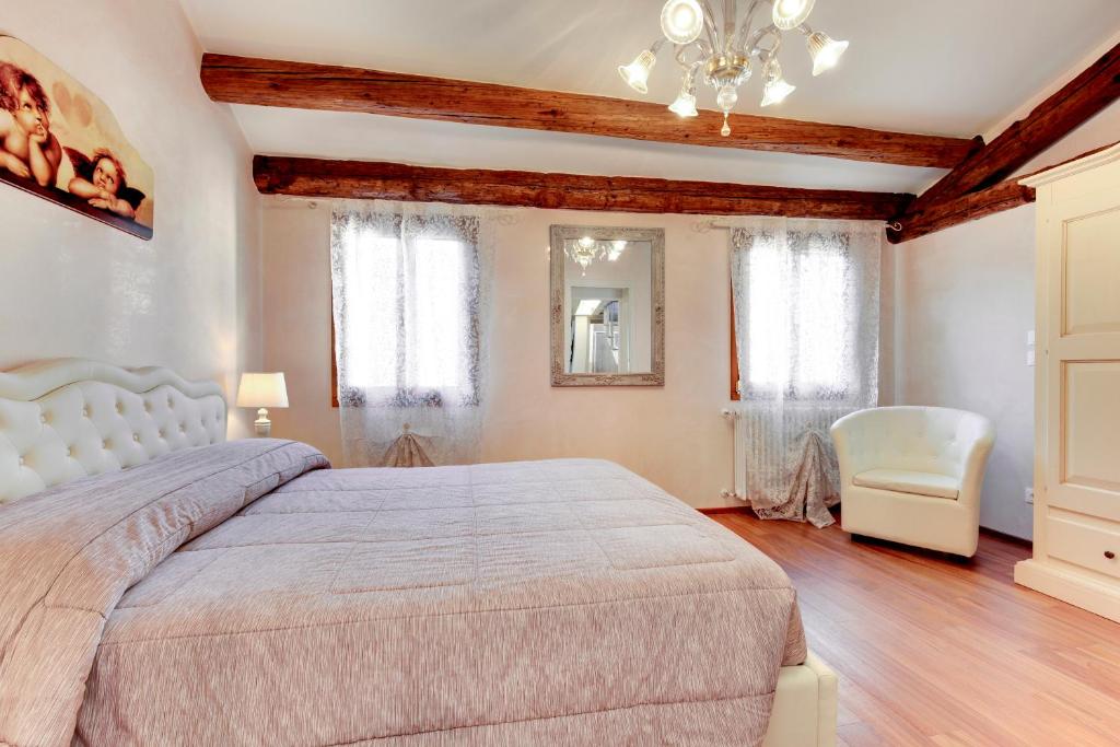 een slaapkamer met een groot bed en een kroonluchter bij The Countess in Venetië