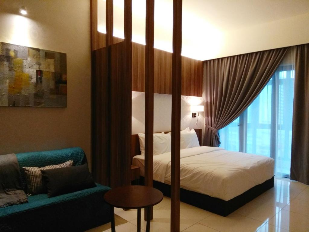 a hotel room with a bed and a couch at DingDong Bukit Bintang Luxury Suites,3mi to PaVlion mall in Kuala Lumpur