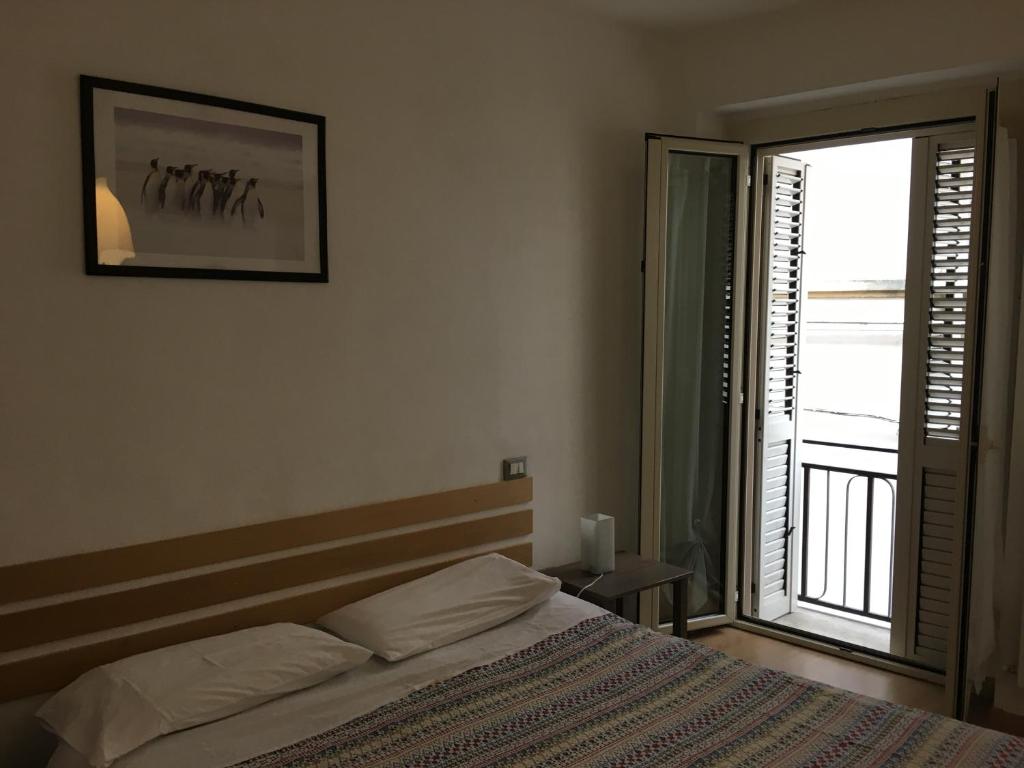 a bedroom with a bed and a large window at La Casetta Due in Teramo