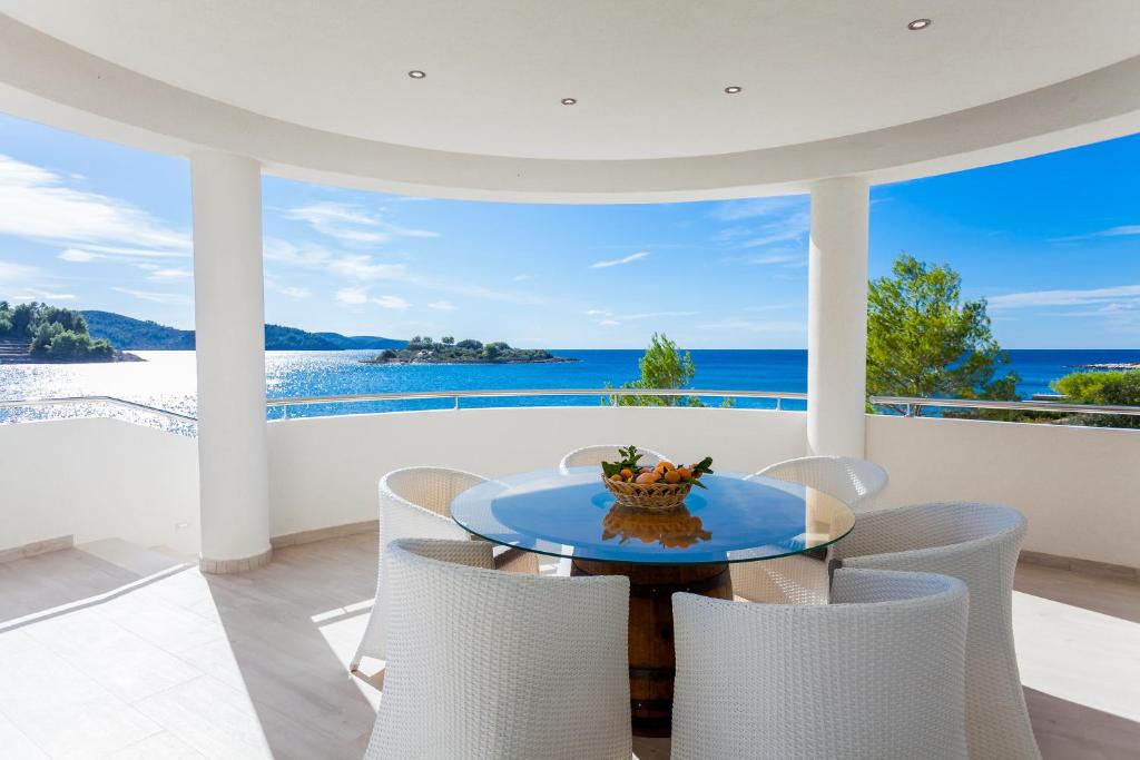 a dining room with a view of the ocean at Villa Soleil in Vela Luka