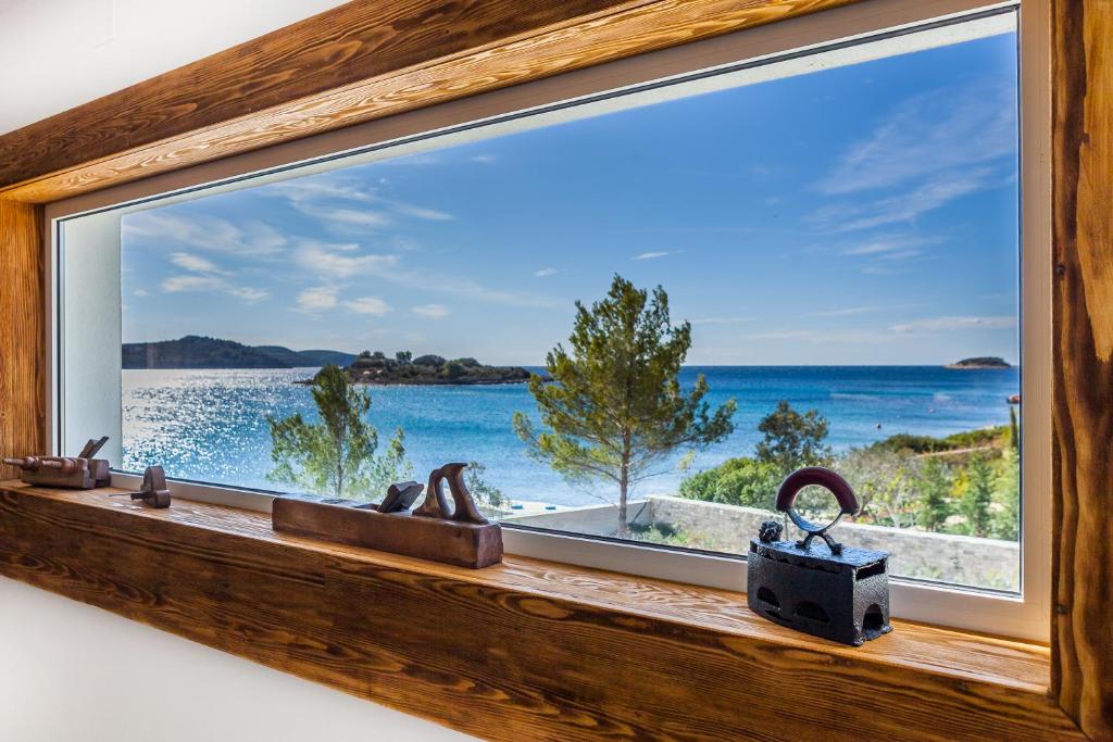 a window with a view of the ocean at Villa Soleil in Vela Luka