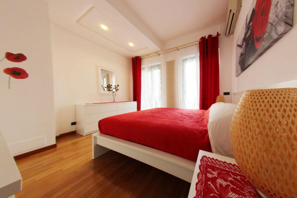 a bedroom with a red bed and a window at Apartment De Rossi in Bari