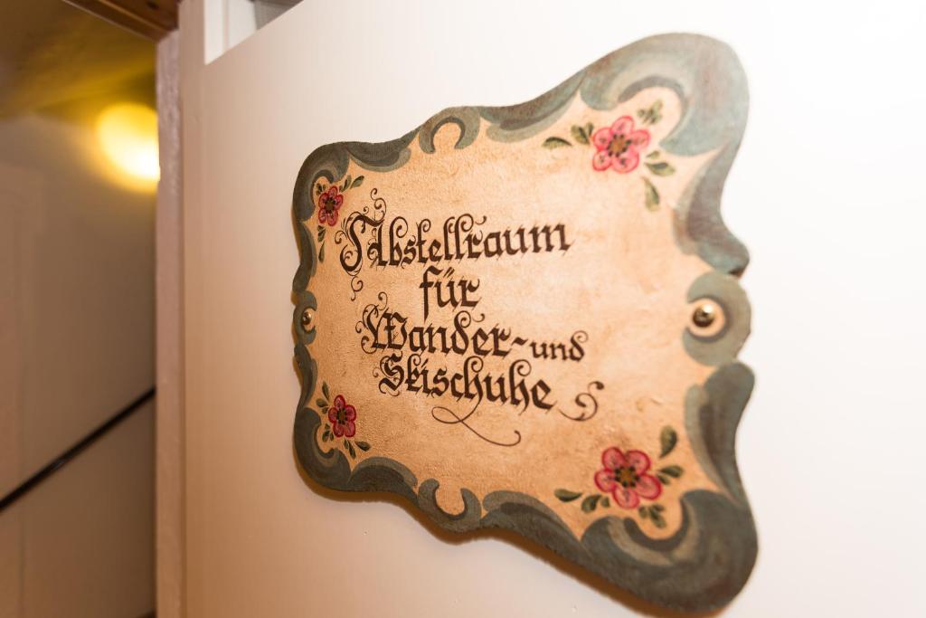a sign on a wall that reads satisfaction is the strength of a existence at DEVA Hotel Kaiserblick in Reit im Winkl