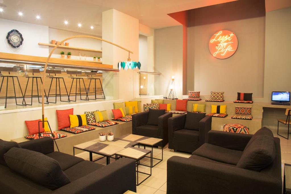 a waiting room with couches and tables in a store at Olympic Hotel in Heraklio Town