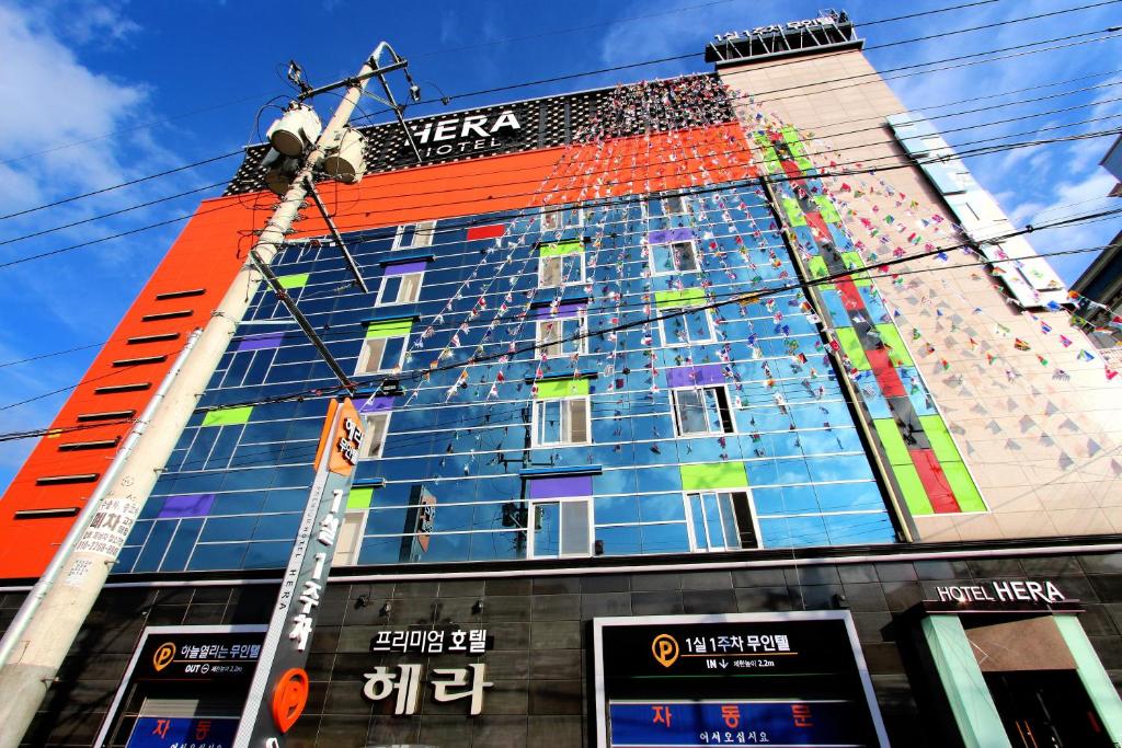 a tall building with a sign on the side of it at Hera Hotel in Daegu