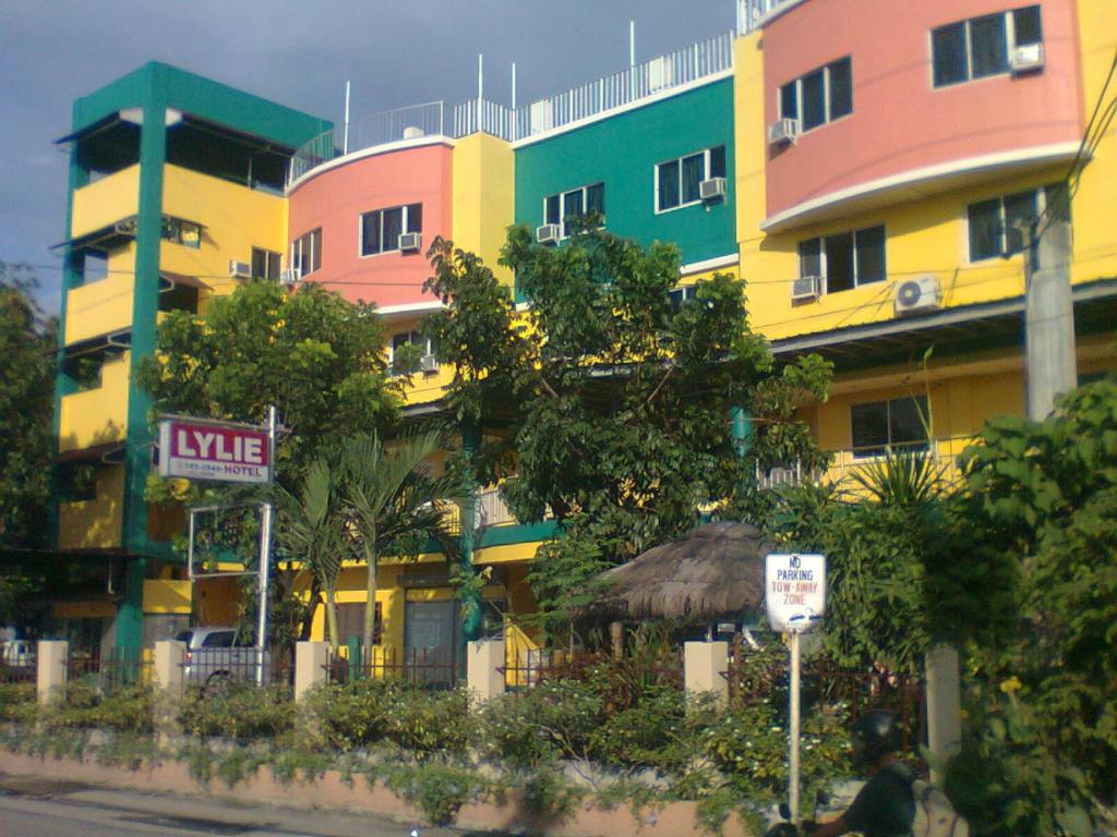 uma linha de edifícios coloridos no lado de uma rua em Lylie Hotel em Cebu