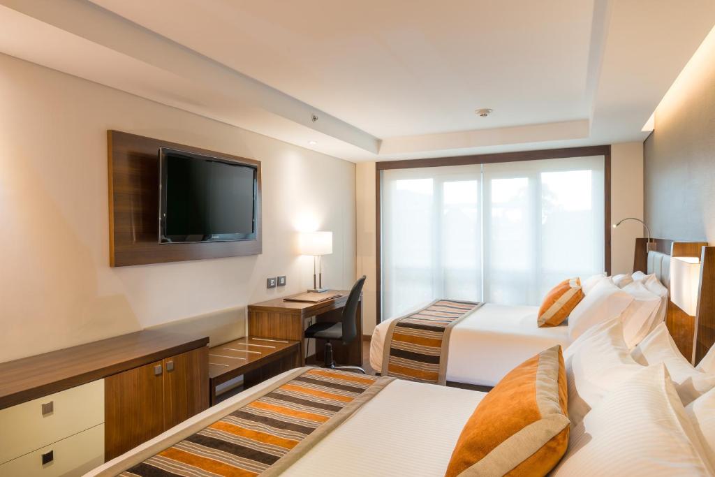 Postel nebo postele na pokoji v ubytování Hotel Dann Carlton Bogota