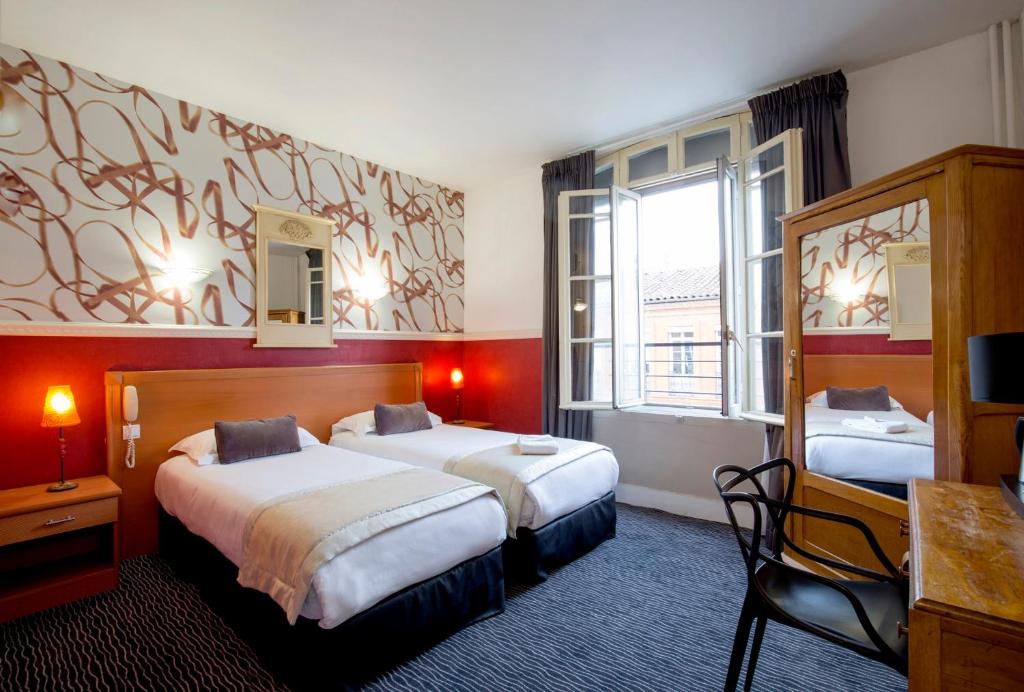 Cama ou camas em um quarto em H&ocirc;tel Raymond 4 Toulouse