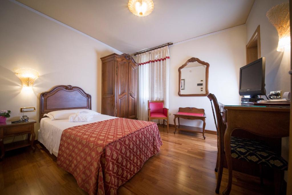Postel nebo postele na pokoji v ubytování Hotel Spessotto