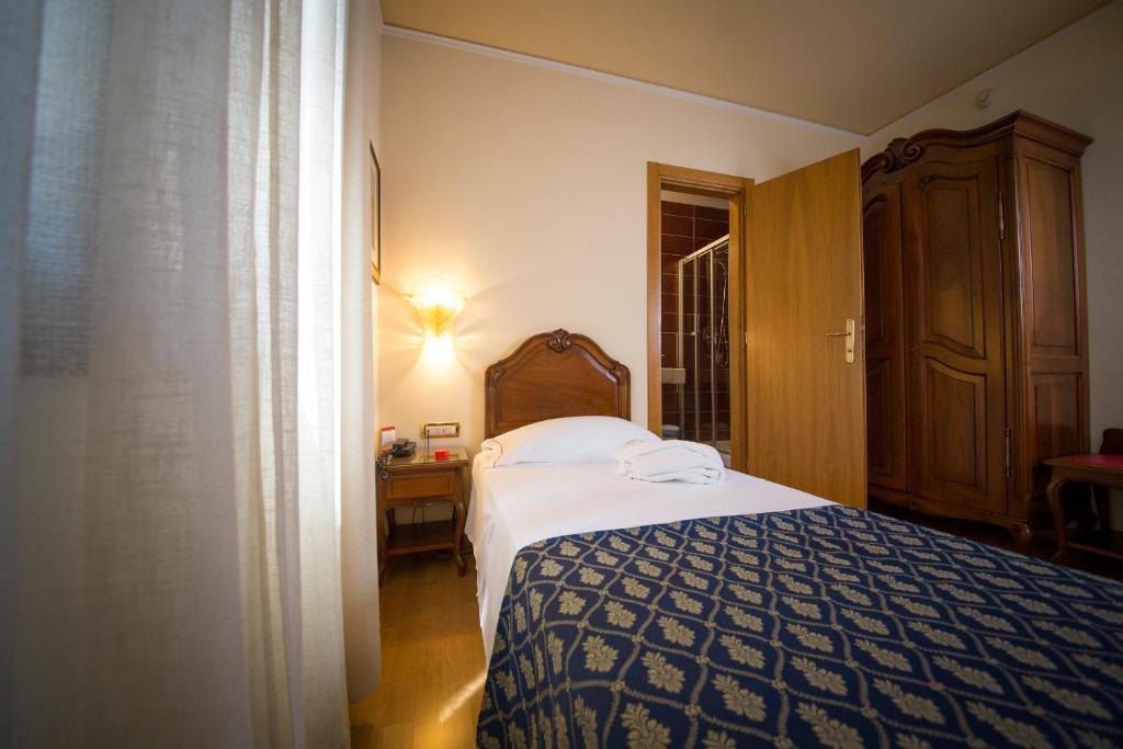 Postel nebo postele na pokoji v ubytování Hotel Spessotto