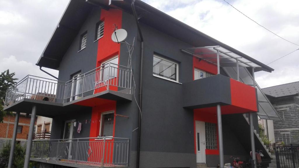 a black and red house with two balconies at Apartman Nadija in Jajce