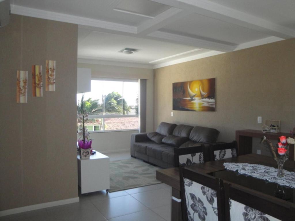 sala de estar con sofá y mesa en excelente apto de 3 quartos com suite e vista mar, en Florianópolis