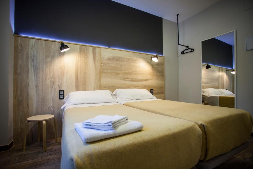 a bedroom with a large bed with towels on it at CC Atocha in Madrid