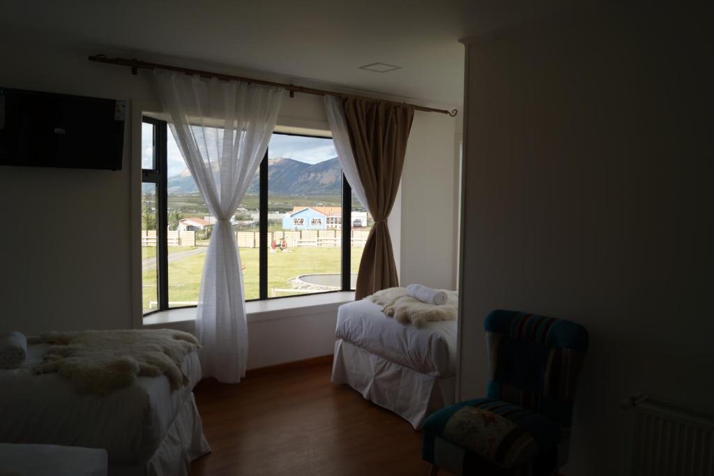 Postel nebo postele na pokoji v ubytování Hostal Doble E Patagonia