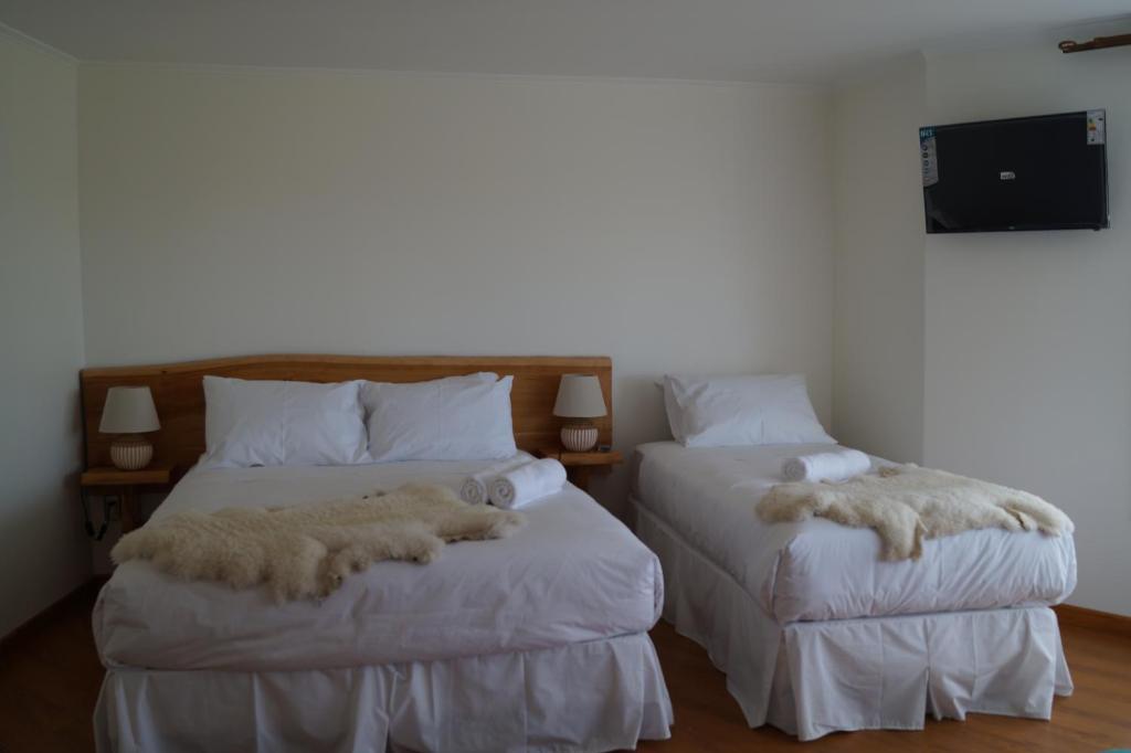 Postel nebo postele na pokoji v ubytování Hostal Doble E Patagonia