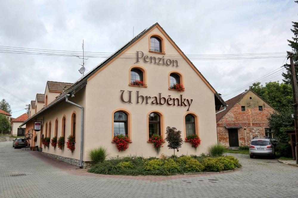a building with the words benion university on it at Penzion U Hraběnky in Petrovice
