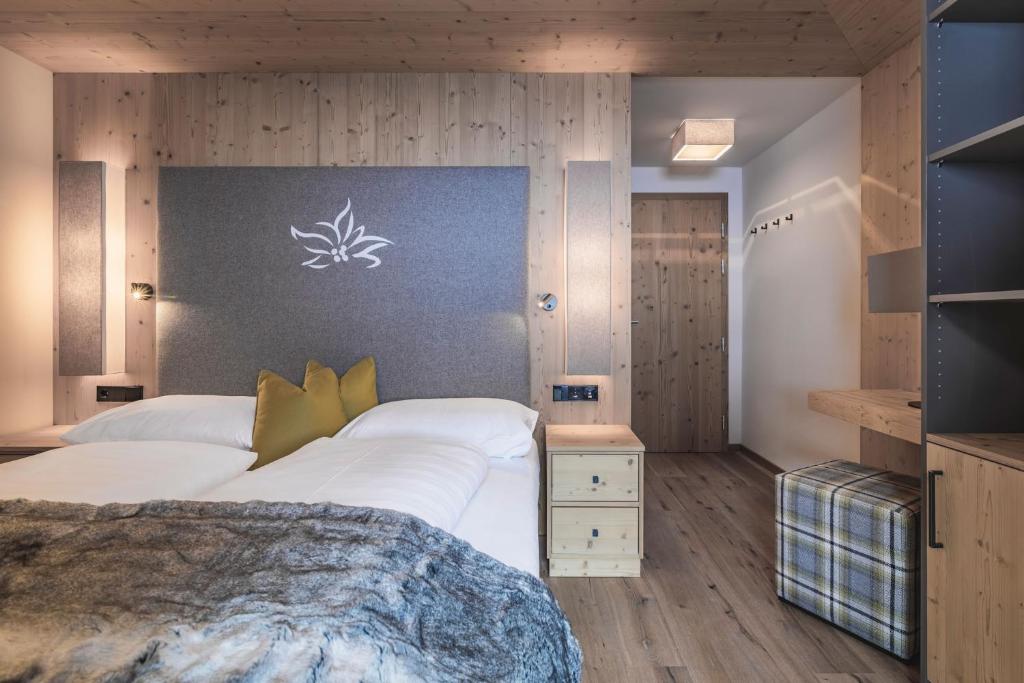 Postel nebo postele na pokoji v ubytování Hotel & Chalets Edelweiss