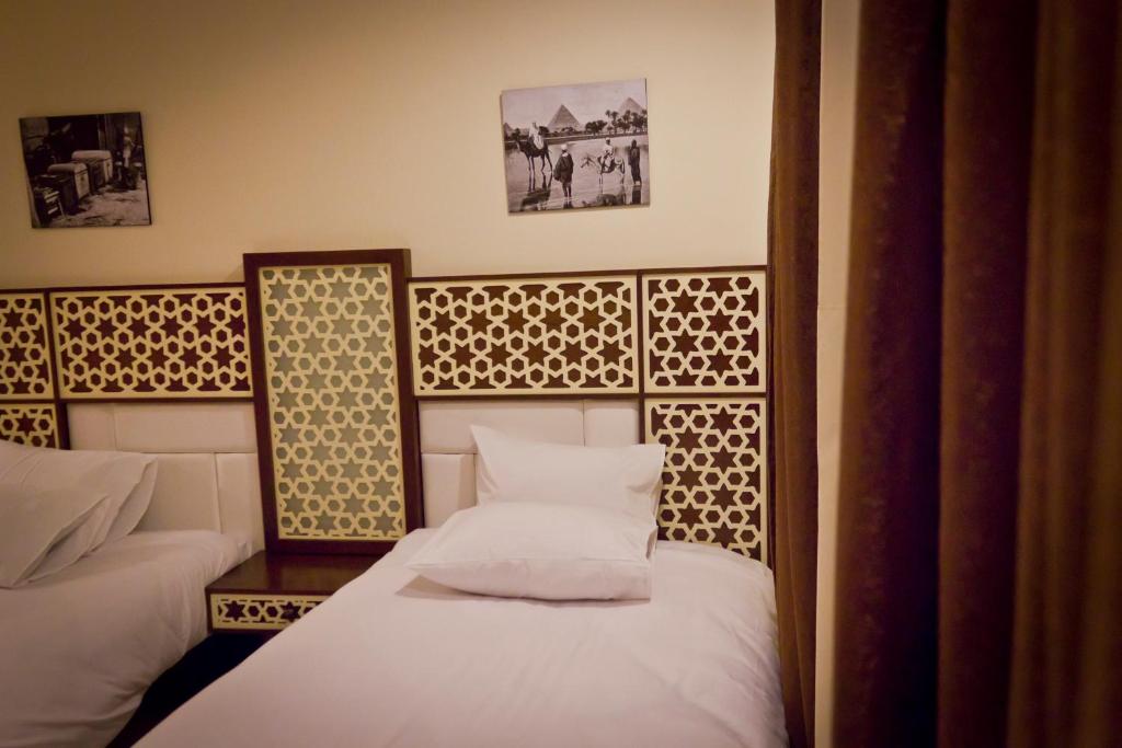 Postel nebo postele na pokoji v ubytování Pyramids Valley Boutique Hotel