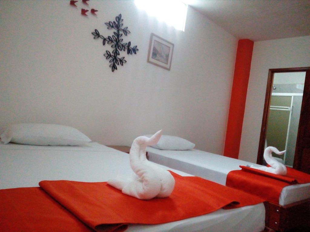 Postel nebo postele na pokoji v ubytování Hostal El Pinzón