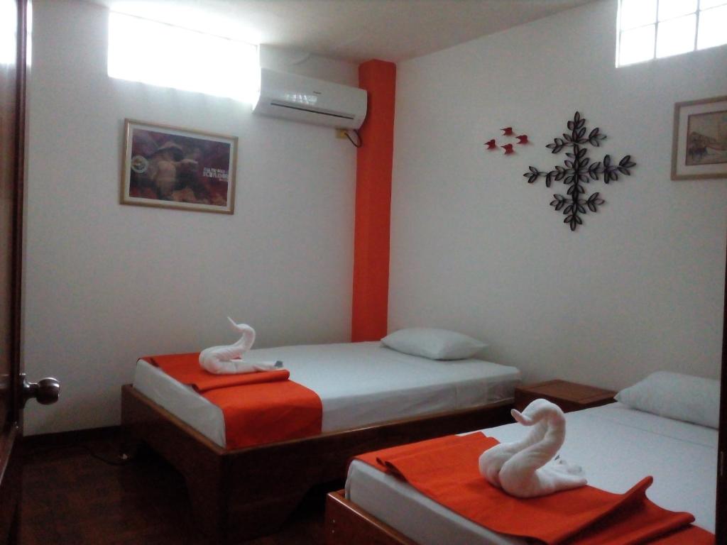 Postel nebo postele na pokoji v ubytování Hostal El Pinzón