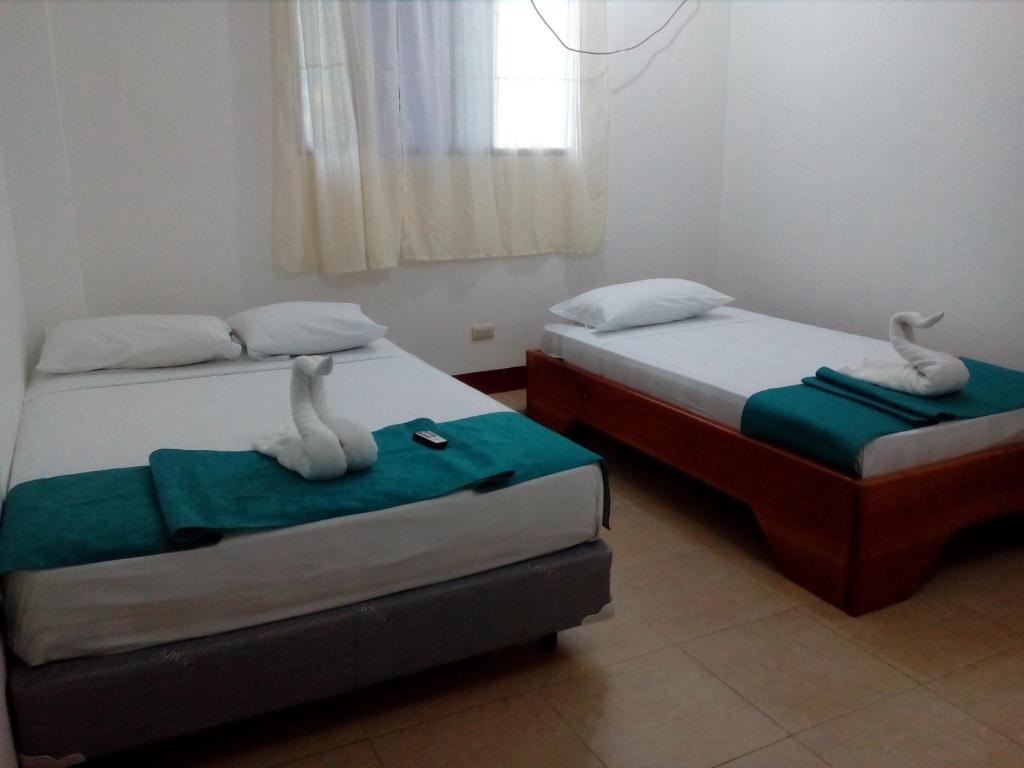 Postel nebo postele na pokoji v ubytování Hostal El Pinzón