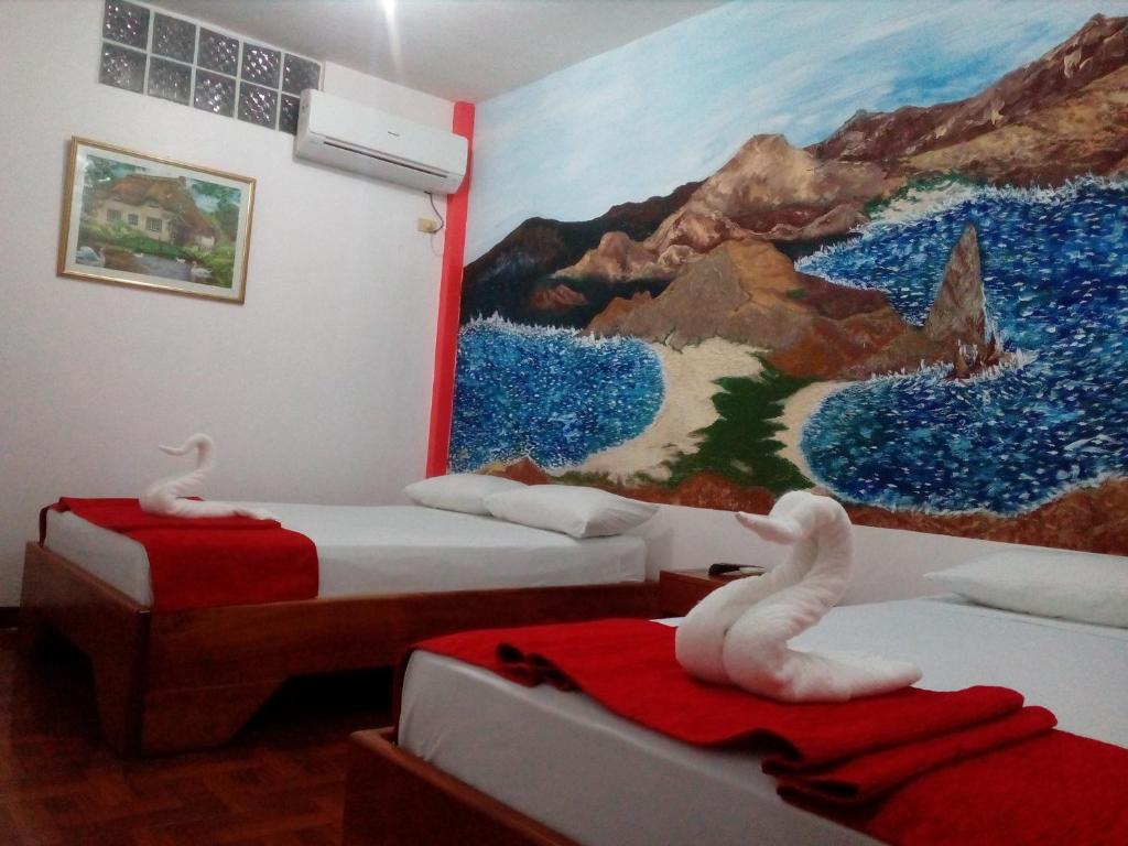 Postel nebo postele na pokoji v ubytování Hostal El Pinzón